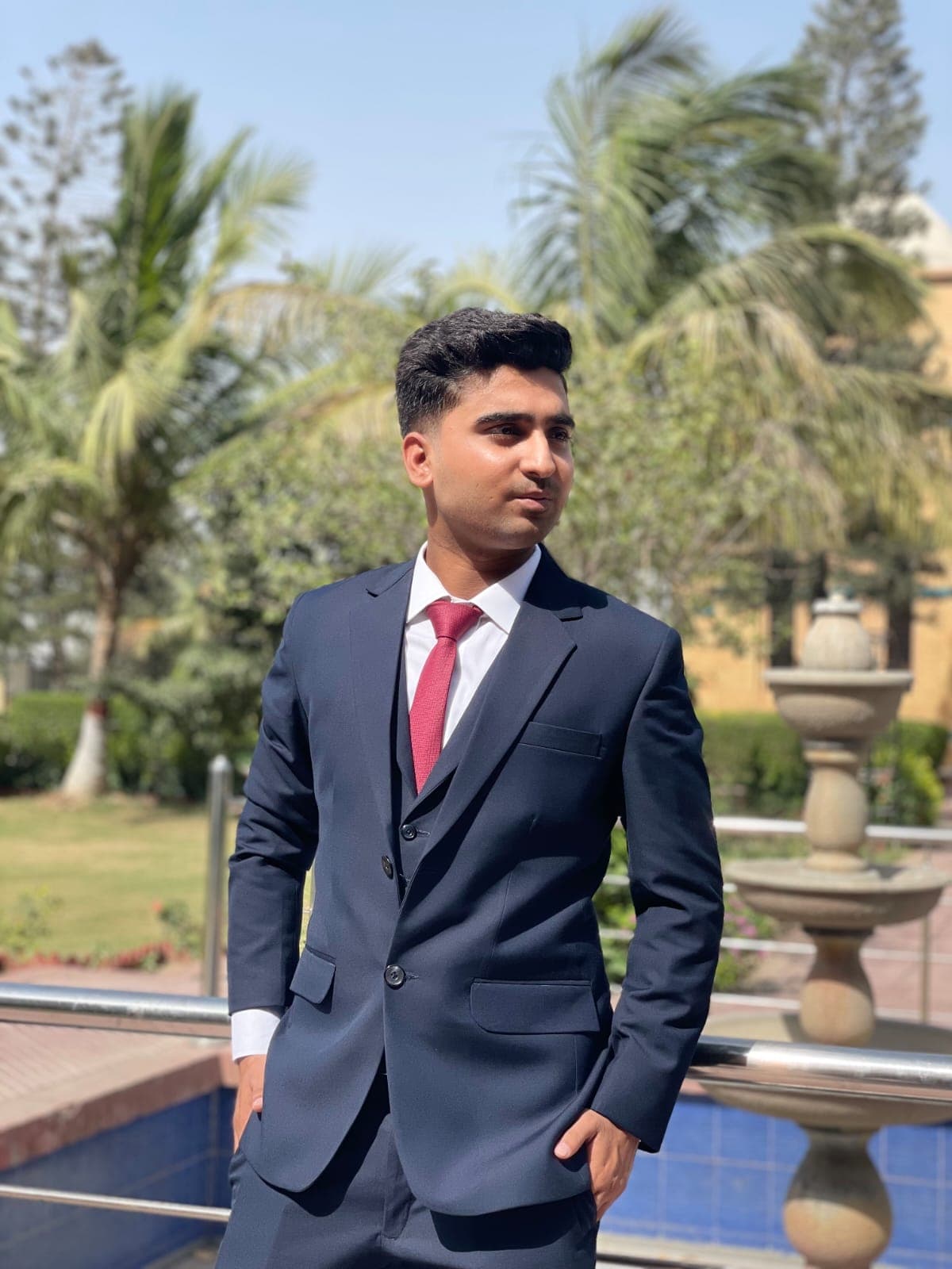 Muneeb Ur Rehman standing by a fountain